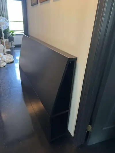 IKEA headboard for a queen/double sized bed, in black-brown colour. Has storage on the sides. Measur...