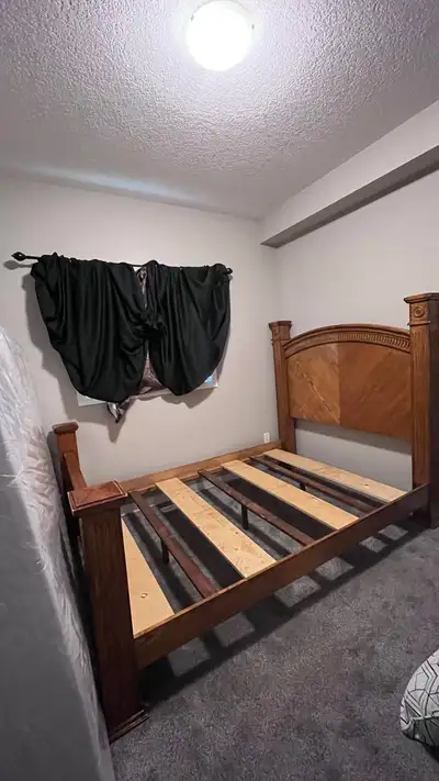 Selling a solid wood bed frame. Fits a Queen sized mattress. Used but in overall good condition. Loc...