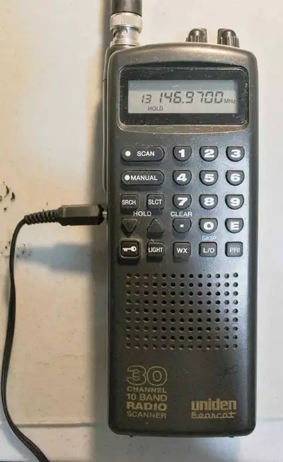 Two scanners, Radio Shack PRO-2009, and Uniden Bearcat Portable 30 channel scanner. Uniden scanner f...