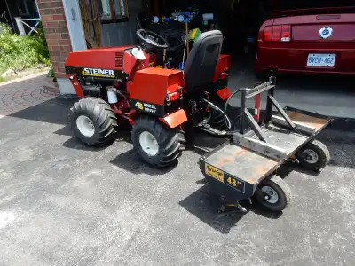 Lawn tractor with trailer and equipment.