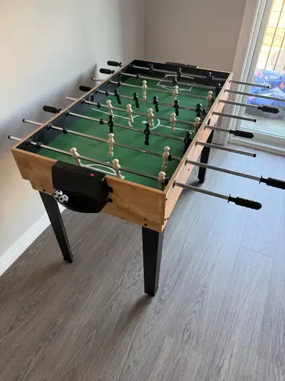 Foosball table with pool table and other games