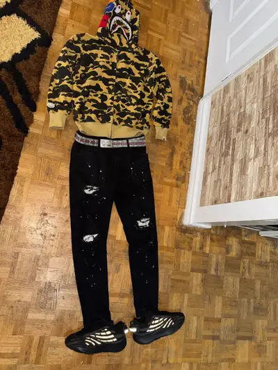 Men's outfit bundle. Features a Bape camo zip-up hoodie, black distressed skinny jeans, and yezzy bo...