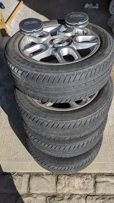 4 Alloy FIAT Rims in good condition with 185/55R15 Firestone summer tires. With hub caps.