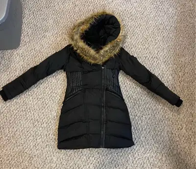 Women's black puffer coat. Long length, fitted waist. Faux fur trimmed hood. Multiple pockets. Good...