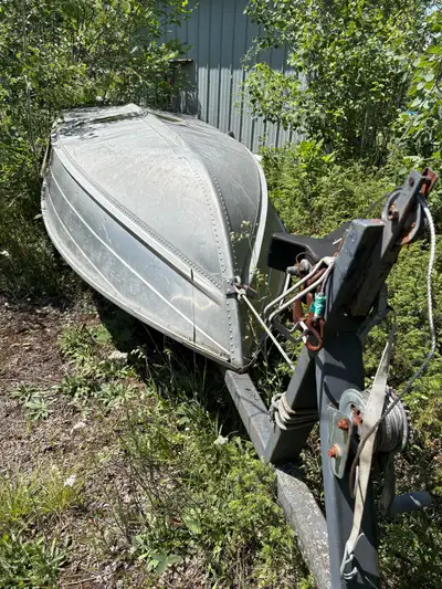 11’ Grumman Aluminum Boat with Trailer and 6 hp Suzuki outboard complete with fuel tank.