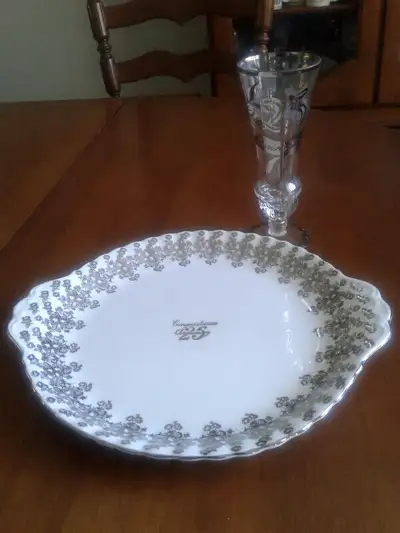 Bone china cake plate made in England, plus a silver embossed vase. Choice $5