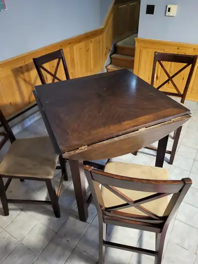 Table set with four chairs. Sturdy and kept well. Sides fold up to make it round. Chair fabric is in...