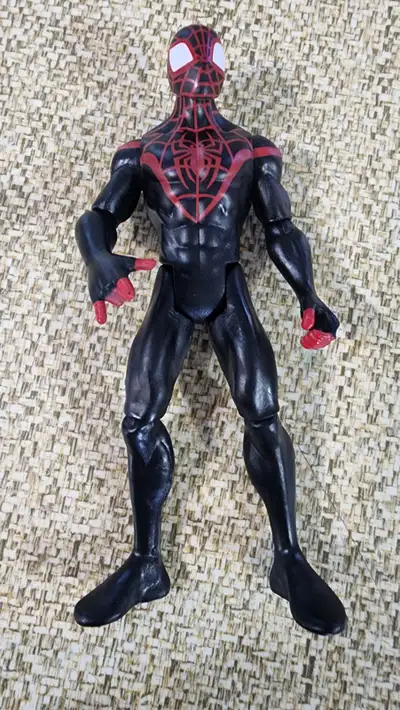 Unleash the power of the Marvel Legends series with the Ultimate Spider-Man Miles Morales action fig...