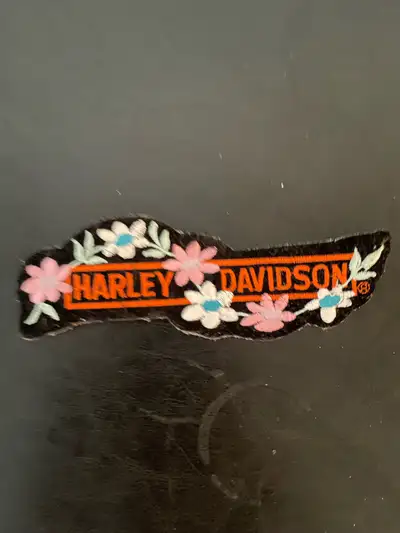 Add a touch of biker chic to any outfit with this used Harley Davidson floral patch! This unique pat...