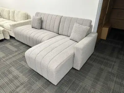 This stylish grey sectional sofa features a modern design with clean lines and comfortable cushions,...