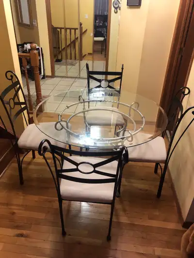 This glass top table with 4 padded chairs is perfect for a dining nook or small kitchen. The set is...