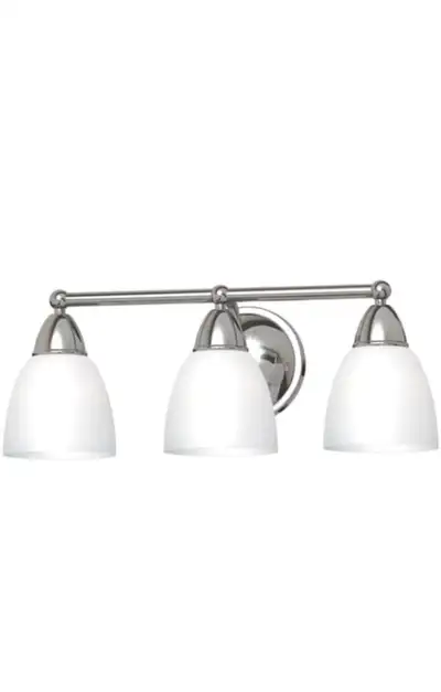New in box three-light vanity fixture. Brushed nickel finish. White glass shades. Operates on 3 medi...