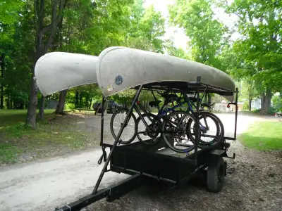 A custom built trailer that can carry four canoes/kayaks, or four bicycles and two canoe/kayaks. The...
