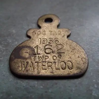 Crafted with a nod to nostalgia, this 1966 Waterloo Township Dog Tag #162 is a unique pendant jewelr...