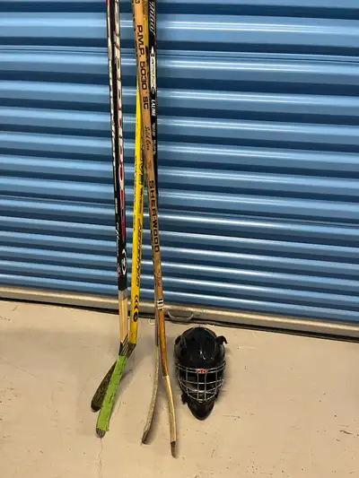 Hockey sticks and goalie helmet, View more