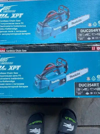 Brand new Makita chainsaws two available comes with battery charger chain new in the box