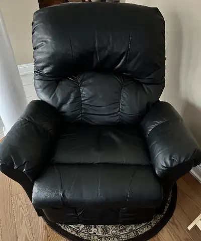 Create a warm and welcoming setting for your family with this reclining swivel chair. Wrapped in dur...