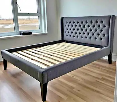 This queen size bed frame features a stylish grey, tufted headboard, making it a chic addition to an...