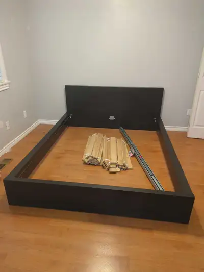 Black Ikea bed frame with 2 nightstands that can optionally be attached on either side. Comes with f...