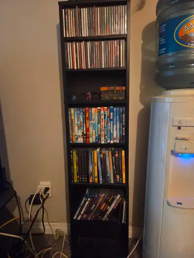 This tower fits CD's and DVD's. The dimensions are: 54" high, 13" wide, 6 " deep