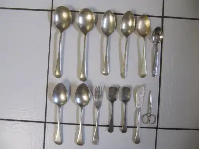 Up for sale is a twelve piece lot of mid century silver; nickle; brass; stainless cutlery in good cl...