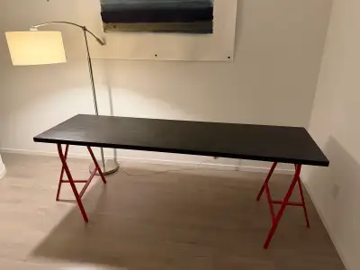 This is a used desk. * Brand: IKEA * Colour: Black top with red legs * Dimensions: Length is 200cm