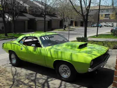 Own a piece of automotive history with this vibrant green 1974 Plymouth Barracuda, known as the 'Cud...
