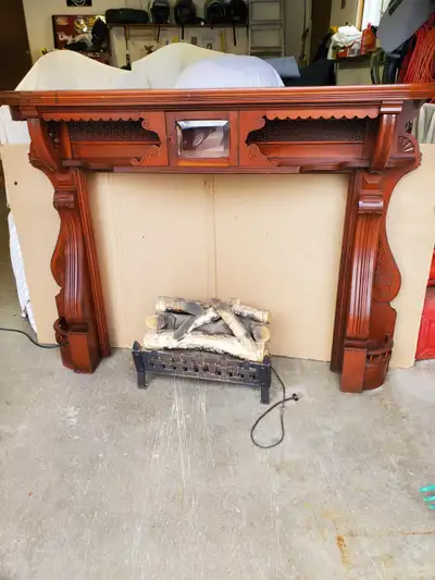 I am selling a solid wood, antique fireplace mantel, with glass display area and beautiful detail. C...