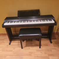 Selling  Roland digital piano with seated bench.