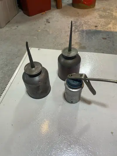 three oil pump cans , View more