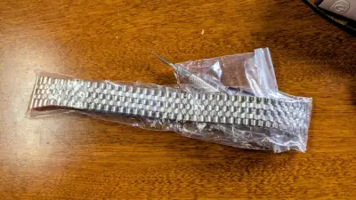 20 mm width. Bought this without realizing my watch needs a 22mm watch band, this one includes pins....