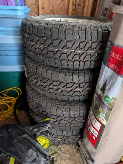 Set of 4 Falken Wildpeak A/T 4 W XL M&S tires on 2002 jeep rims with centre caps. 235/70/R16. Brand...