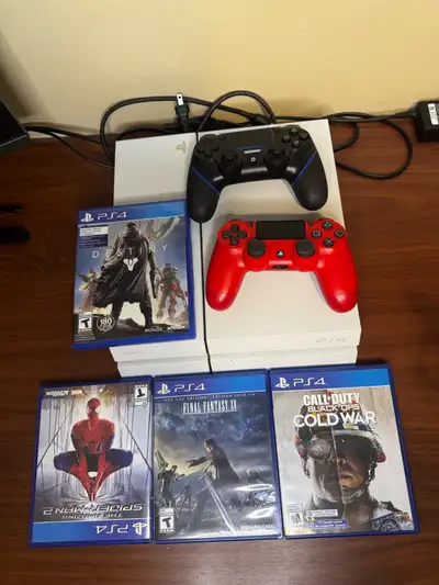 Comes with 2 controllers, 4 games, cables, and original box. Includes Spider-Man, Destiny, Final Fan...