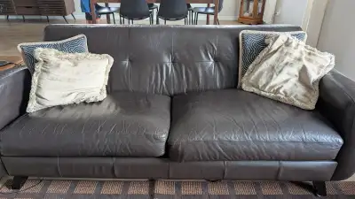 Beautiful dark brown leather sofa and loveseat set, perfect for adding comfort and style to your spa...