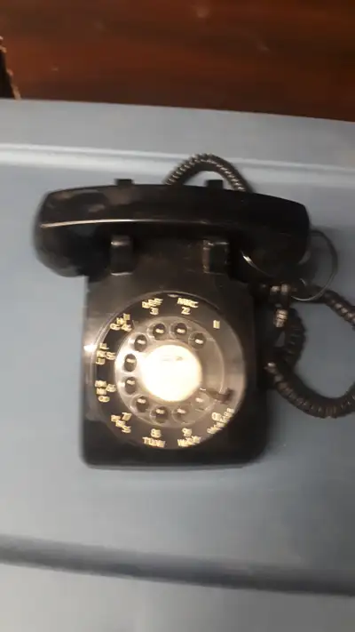 Old black rotary phone. Would need refurbishment to be functional. Fun conversation piece or stage p...