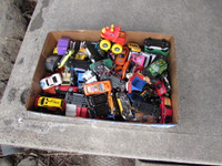 Mixed bunch of miniature toy trucks and cars