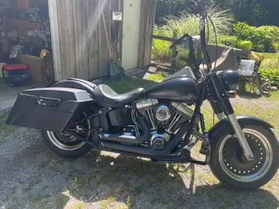 Flat black fatboy for sale. Vance and Hines short shot pipes, carlini ape bars, aftermarket saddle b...