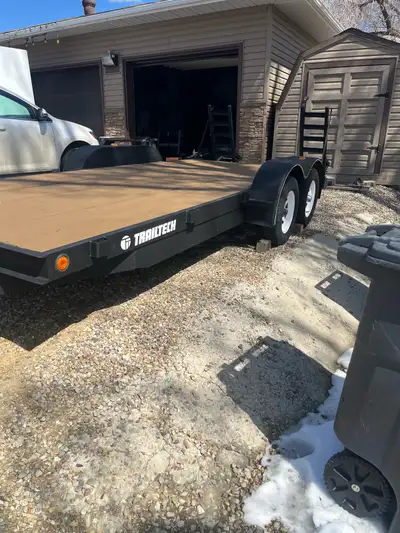 I'm selling a Trailtech 18.5-foot equipment hauler with a beaver tail and fold-down ramps. This trai...