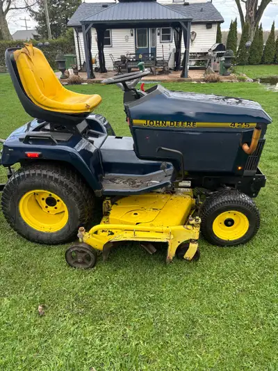 John Deere 425 a lot of love time and money spent on this tractor!! Engine was torn down and replace...