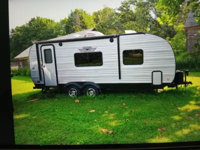 Well-maintained Riverside RV Retro 189R travel trailer has a silver aluminum exterior with black tri...