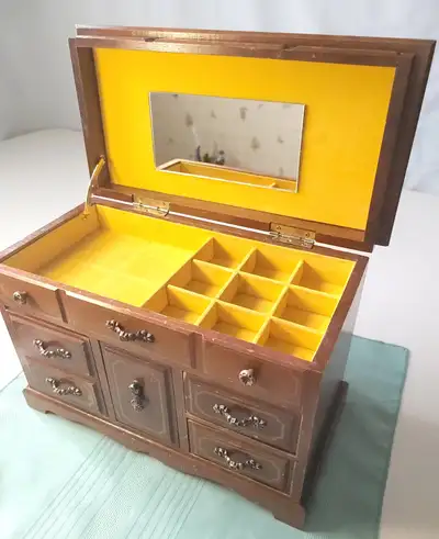Step back in time with this vintage 1970s miniature dresser-style musical jewelry chest! Stamped "Ma...