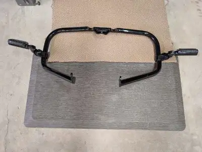 Harley Davidson Soft tail engine guard with Hi way foot pegs. Black some scratches from lowers that...
