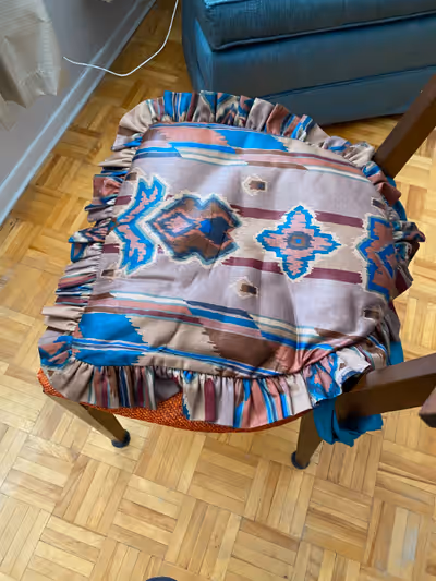 Two Table Chair seat cushions. Hand washable. Fabric ties to wrap around two legs of the chairs. Han...