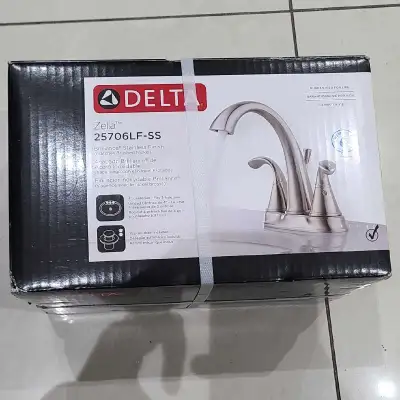 Brand new sealed box, Delta Zella two handle centerset faucet in stainless (brushed nickel) finish P...