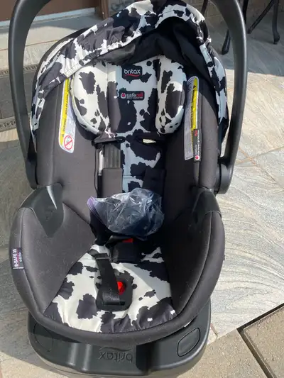 I'm selling a Britax infant car seat with a stylish cow print design, suitable for newborns up to ap...