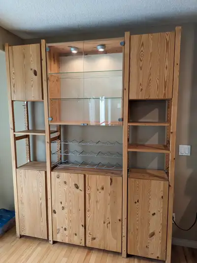 Ikea solid pine storage cabinet/china cabinet, clear varnish finish. Glass display in middle with gl...