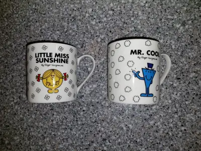 Here are two licensed mugs, Little Miss Sunshine and Mr. Cool of the "Mr Men" book series. They're m...