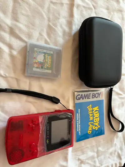 Red gameboy colour, new shell, comes with case, game, manual and batteries, $300 obo