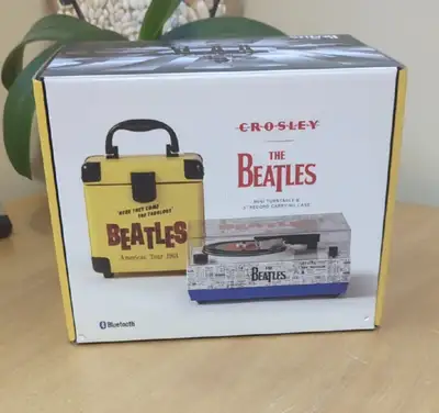 Immerse yourself in the timeless tunes of The Beatles with this new, in-box Crosley mini turntable a...