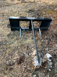 Like new skid steer attachment three prong bale spear.